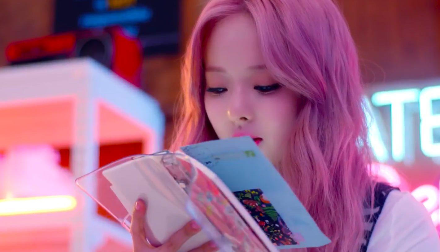 Vivi flipping through a book, from the 'Everyday I Love You' music video.